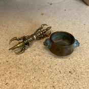A small patinated bronze Chinese censer with lion's head handles on a short circular foot with an