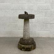 An early 20th century stone birdbath in five parts having a small carved frog finial in an octagonal