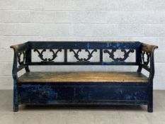 A late 19th century Scandinavian painted and distressed pine box settle having a square openwork