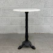 A 20th century French style bistro table having a circular thumb moulded white marble top raised