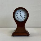 An Edwardian mahogany balloon shaped mantle clock with satinwood and ebony inlay. H.22cm