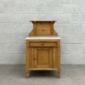 A C.1900 pine washstand having a moulded and shaped superstructure on a white marble surface above a