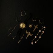 A collection of yellow metal and hallmerked 9ct gold to include four rings, two pendants, a