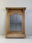 An earlyt 20th century wall mounted pine mirror having a moulded cornice with shaped corbels above a