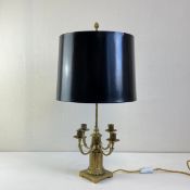 An early 20th century brass table lamp having an acorn finial on a narrow stem with three light
