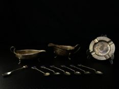 Three hallmarked silver items; Two sauceboats and an ashtray and a collection of white metal spoons.