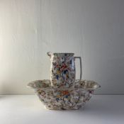 An early 20th century Royal Corona ware Rosetta pattern jug and bowl of square form with allover