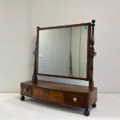 A Georgian mahogany toilet mirror fitted with three base drawers raised on bun feet. In need of a