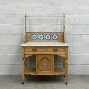 An early 20th century pine washstand having a tiled gallery back with a curtain rail supported by