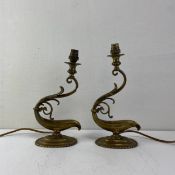 A pair of early 20th century brass table lamps each having a splayed light fitting finial raised