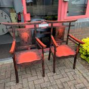A pair of Chinese lacquered armchairs with carved foliate decoration.