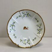 An early 19th century duck egg porcelain cruciform dish having a central gilt dolphin crest