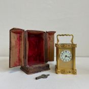 A C.1900 brass carriage clock by The London Jewellers & Silversmiths Co having a shaped handle above