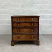 A Georgian mahogany chest of drawers having a rectangular crossbanded top with a central inlaid oval