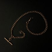 A gold Albert chain with t-bar and hallmarked fob with indistinct maker's marks, marked 9ct and