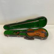 A 20th century violin or fiddle with a single panel back complete with a bow in a fitted baize lined
