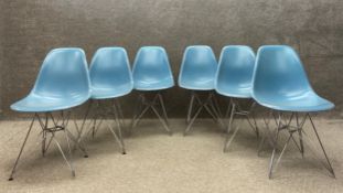 A set of six moulded and painted plastic dining chairs raised on 'Eiffel Tower' chrome supports