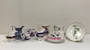 A collection of 19th century porcelain to include seven Gaudy Welsh and other hand painted jugs