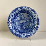 An early 19th century blue and white transfer porcelain bowl having a central vignette depicting two