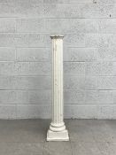 A 20th century carved, painted and distressed Neoclassical style plinth column having a circular top