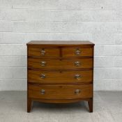 A Georgian mahogany bow fronted chest of drawers having a crossbanded top above an arrangement of