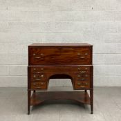 A Georgian mahogany campaign style kneehole writing desk in two parts having a rectangular inlaid
