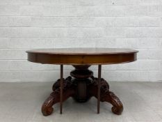 A Victorian mahogany extending dining table having a circular thumb moulded top raised on a heavy