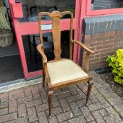 An Edwardian oak Georgian style armchair