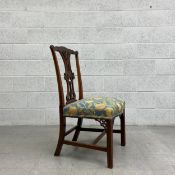 A George III mahogany Chippendale style hall chair having an intricately carved top rail and