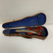 A 20th century Violin or fiddle having a two piece back complete with a bow in a canvas covered