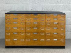 A large contemporary handmade plywood plan chest or chest of drawers having a simple dark grey