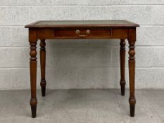 A 19th century oak writing desk having featherbanded top inset with a tooled and gilt green