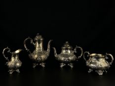 A hallmarked silver Rococo style repousse tea and coffee set to include a creamer, a sugar pot, a