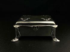 A C.1900 hallmarked silver Arts and Crafts style cedar lined cigarette box by Frederick Courthope