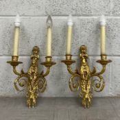A pair of 19th century French Empire style gilt metal wall sconces each having two scrolling
