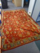 A 20th century Ziegler style carpet having an allover scrolling foliate pattern over an iron red