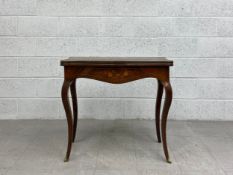 A 19th century French kingwood card table having a marquetry inlaid serpentine fronted top with a