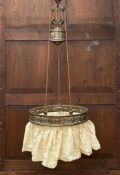 An early 20th century chandelier having a rise and fall action with a weighted counterbalancing