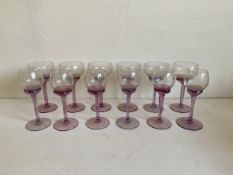 A set of twelve wine glasses with hand blown cranberry stems. H.20cm