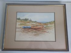 A 20th century watercolour depicting two beached boats on a coastal landscape, signed S. Madden to