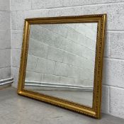 A large contemporary mirror in a gilt moulded frame. H.84 W.95.5cm