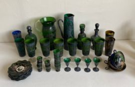 A large part set of green Venetian glass to include two pitchers, three decanters, twenty-three