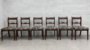 A set of six Regency mahogany bar back dining chairs each having a curved top rail with a