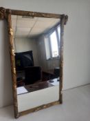 A 19th century pier mirror having a rectangular plate in a gilt reeded frame with leaf and ram's