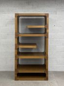 A contemporary retro styled oak open shelving unit having an arrangement of four full and two