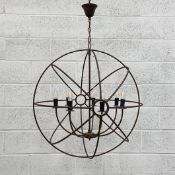 A large vintage wrought iron chandelier of gyroscopic form having seven curved branches suspended