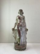 A 20th century Art Deco figural reconstituted stone statue depicting a lady in classical dress