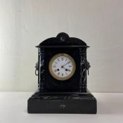 A 19th century French slate mantle clock having a shaped and engraved pediment over the central