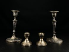 A pair of late 19th century Empire style silver hallmarked candlesticks by Holland, Aldwinckle &