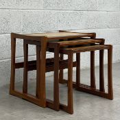 A mid century Danish style teak nest of tables each having a tiled top raised on trestle style